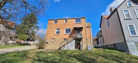 a view of a brick house with a large windows