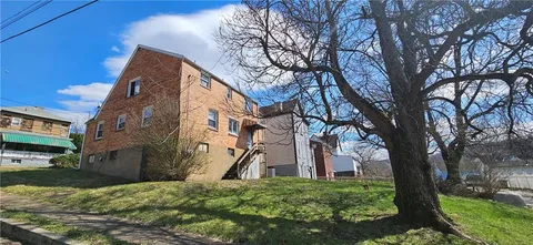 a backyard of a house with large trees