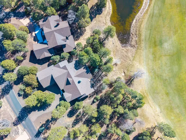 an aerial view of a house with a yard and garden