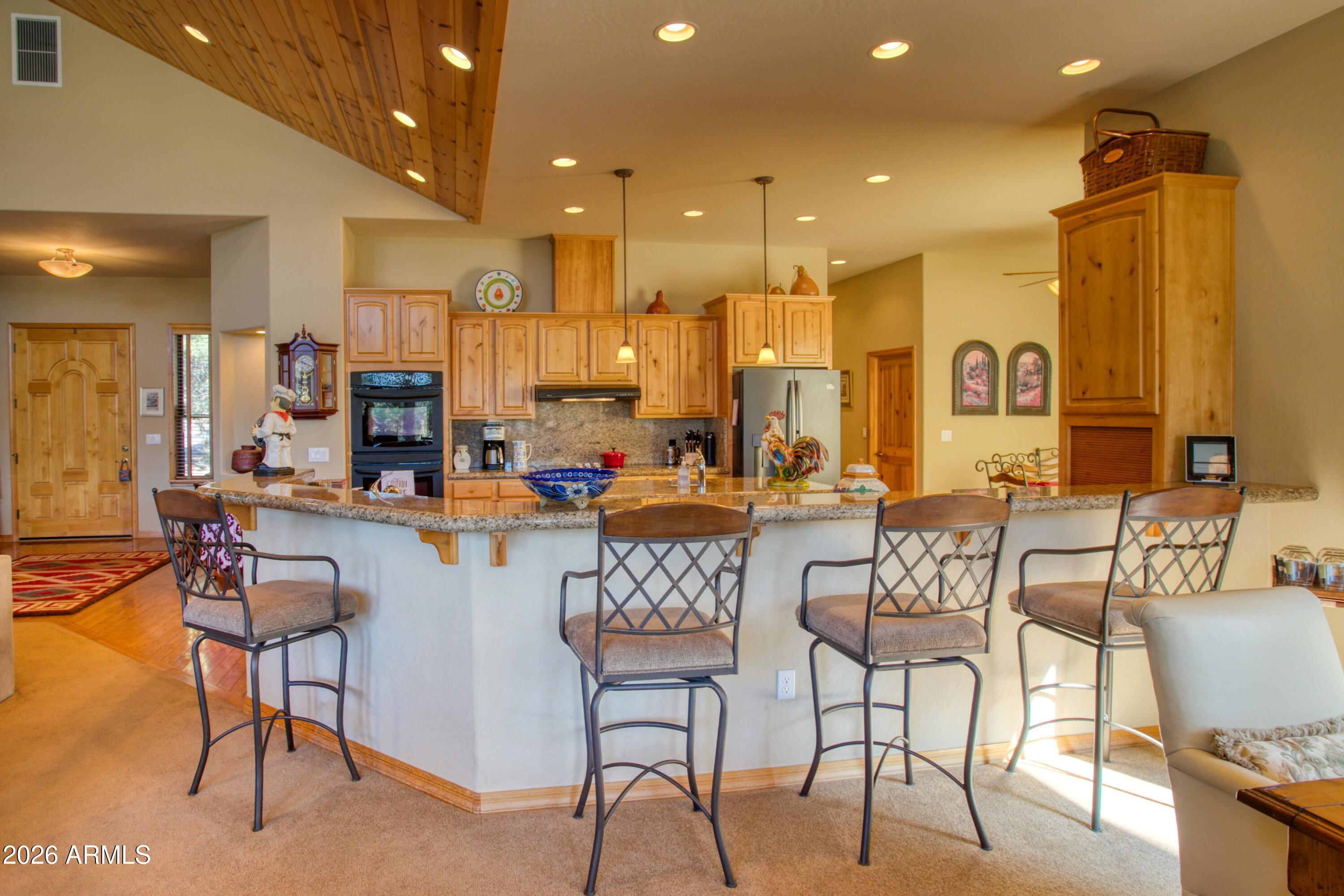 3990 Sugar Pine Loop Show Low, AZ 85901 - Photo 10 of 62 a view of a dining room kitchen with furniture and a chandelier