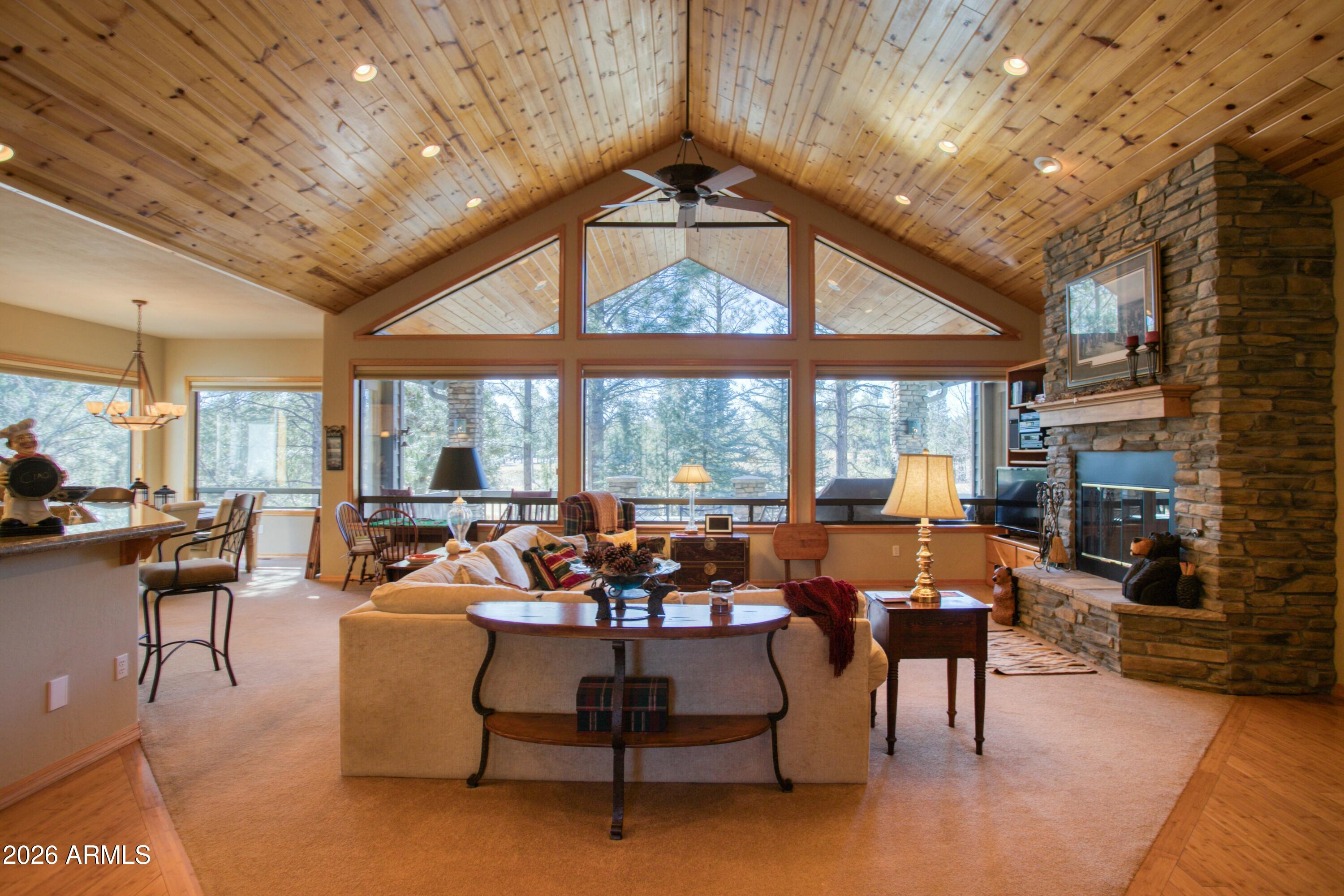 3990 Sugar Pine Loop Show Low, AZ 85901 - Photo 12 of 62 a living room with furniture a fireplace and a table