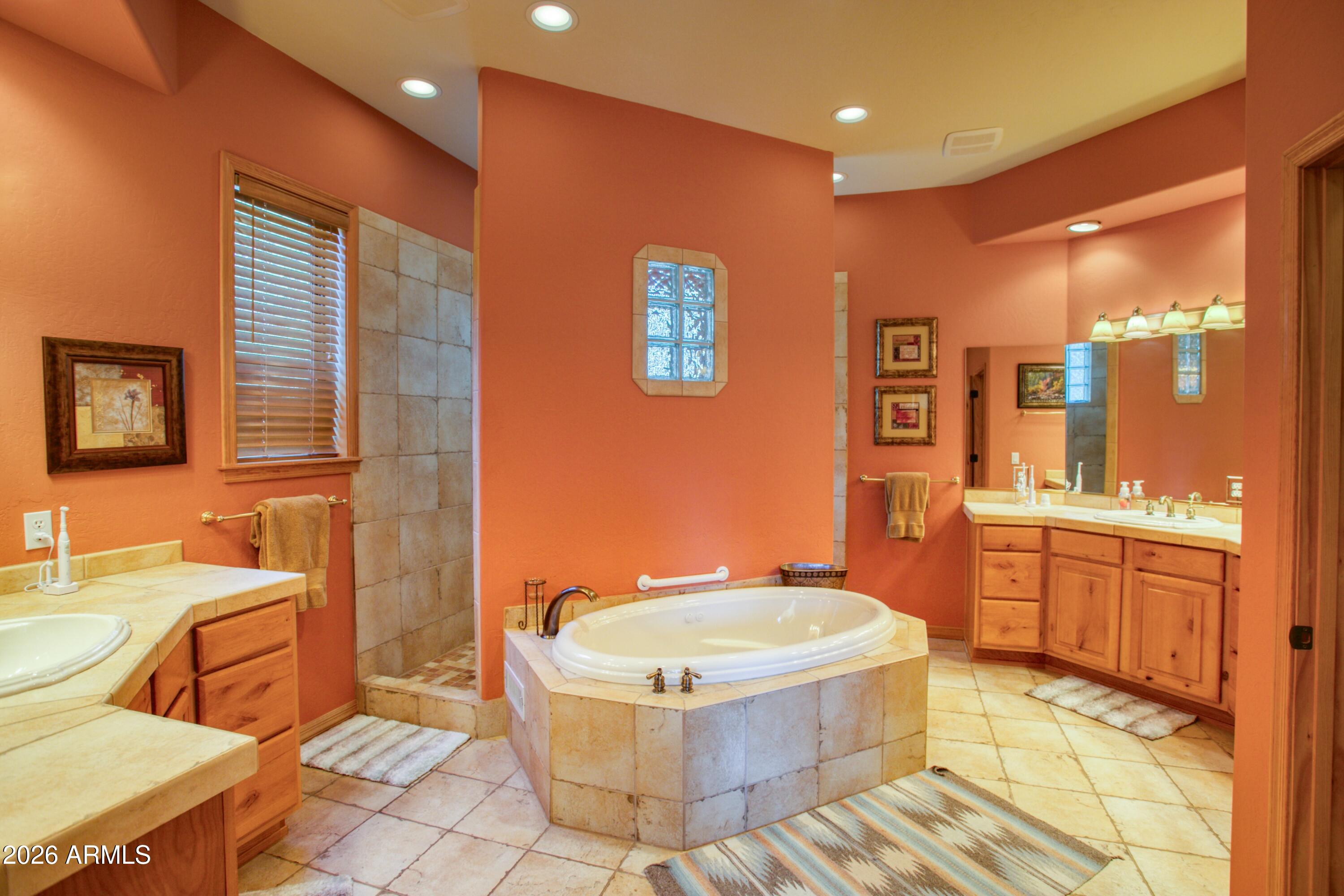 3990 Sugar Pine Loop Show Low, AZ 85901 - Photo 18 of 62 a bathroom with a granite countertop sink a mirror a bathtub and a toilet