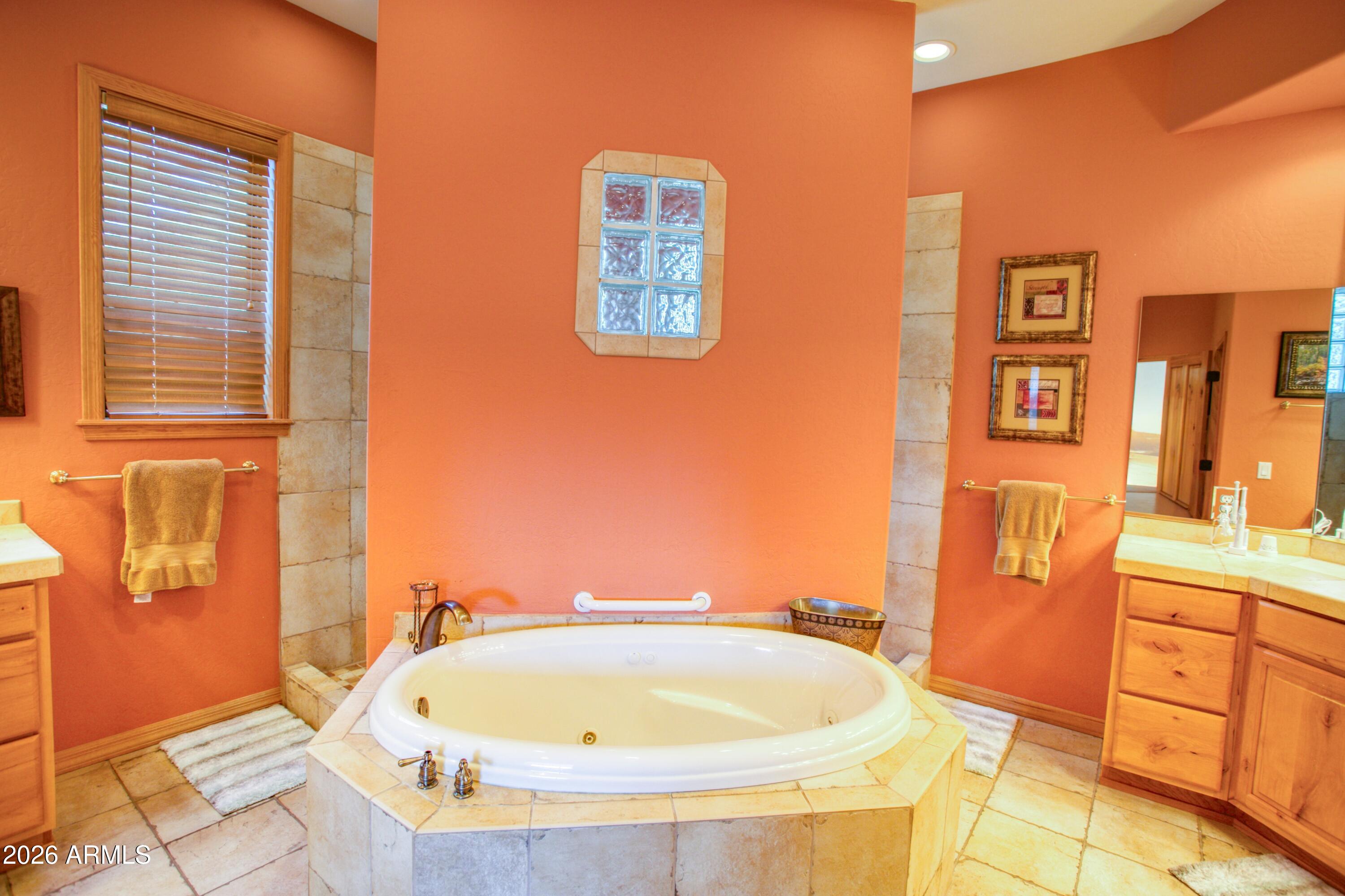3990 Sugar Pine Loop Show Low, AZ 85901 - Photo 19 of 62 a bathroom with a tub sink and mirror