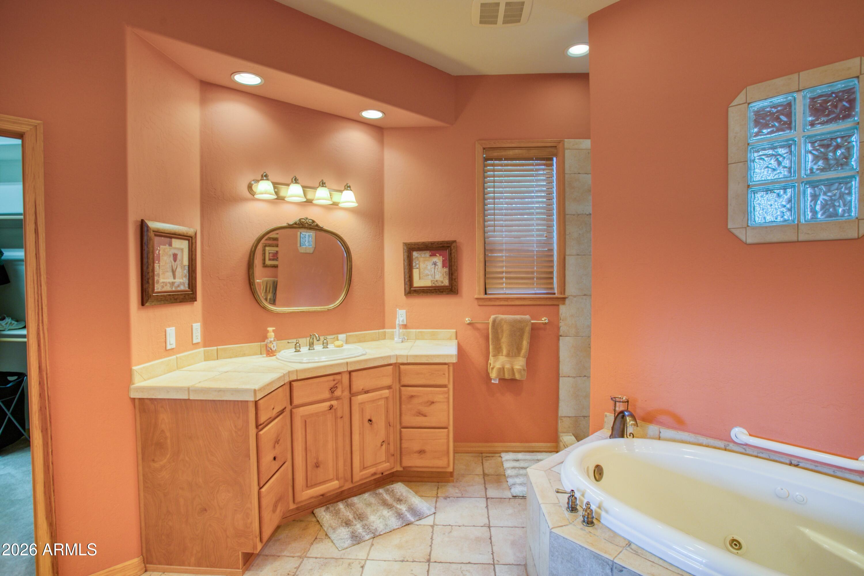 3990 Sugar Pine Loop Show Low, AZ 85901 - Photo 20 of 62 a bathroom with a tub sink and mirror