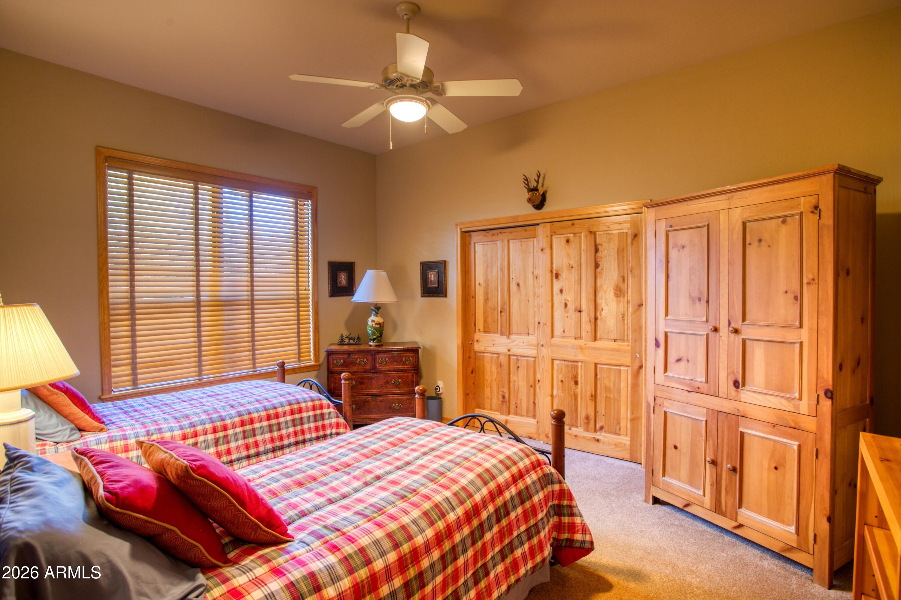 3990 Sugar Pine Loop Show Low, AZ 85901 - Photo 26 of 62 a bedroom with a bed and a chandelier