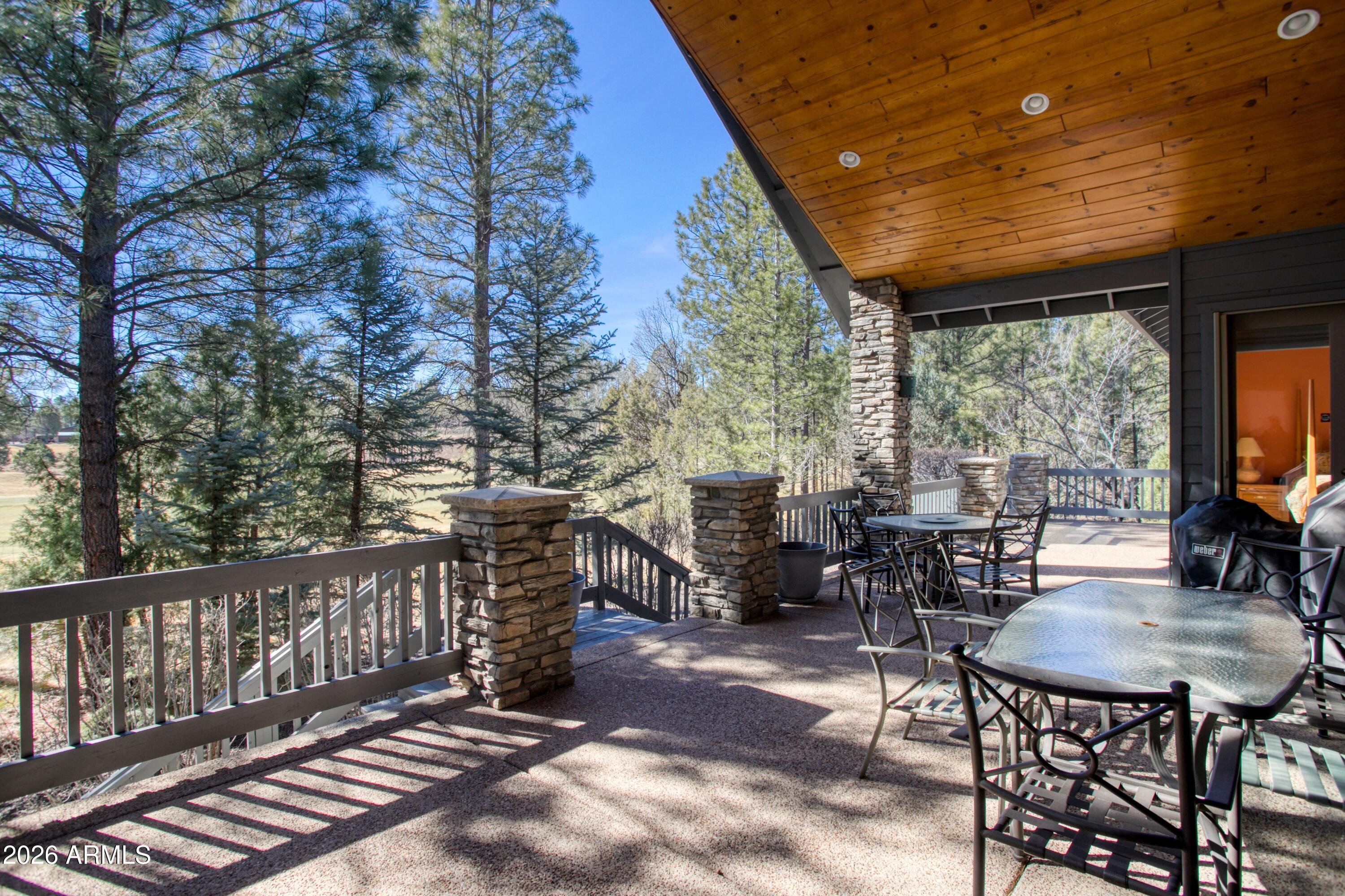 3990 Sugar Pine Loop Show Low, AZ 85901 - Photo 30 of 62 a view of a patio with a table and chairs next to a yard
