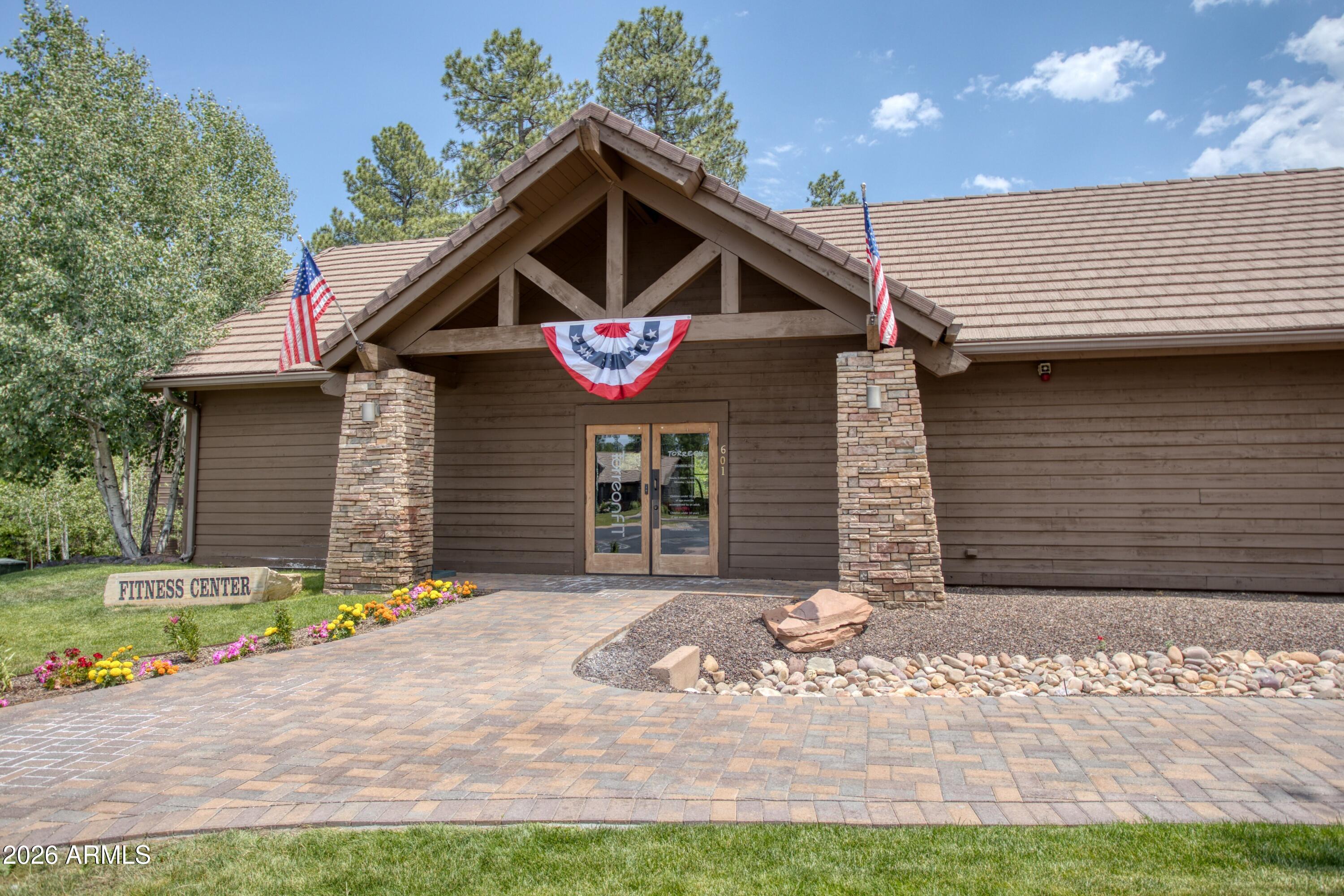 3990 Sugar Pine Loop Show Low, AZ 85901 - Photo 40 of 62 a front view of a house with a yard and garage