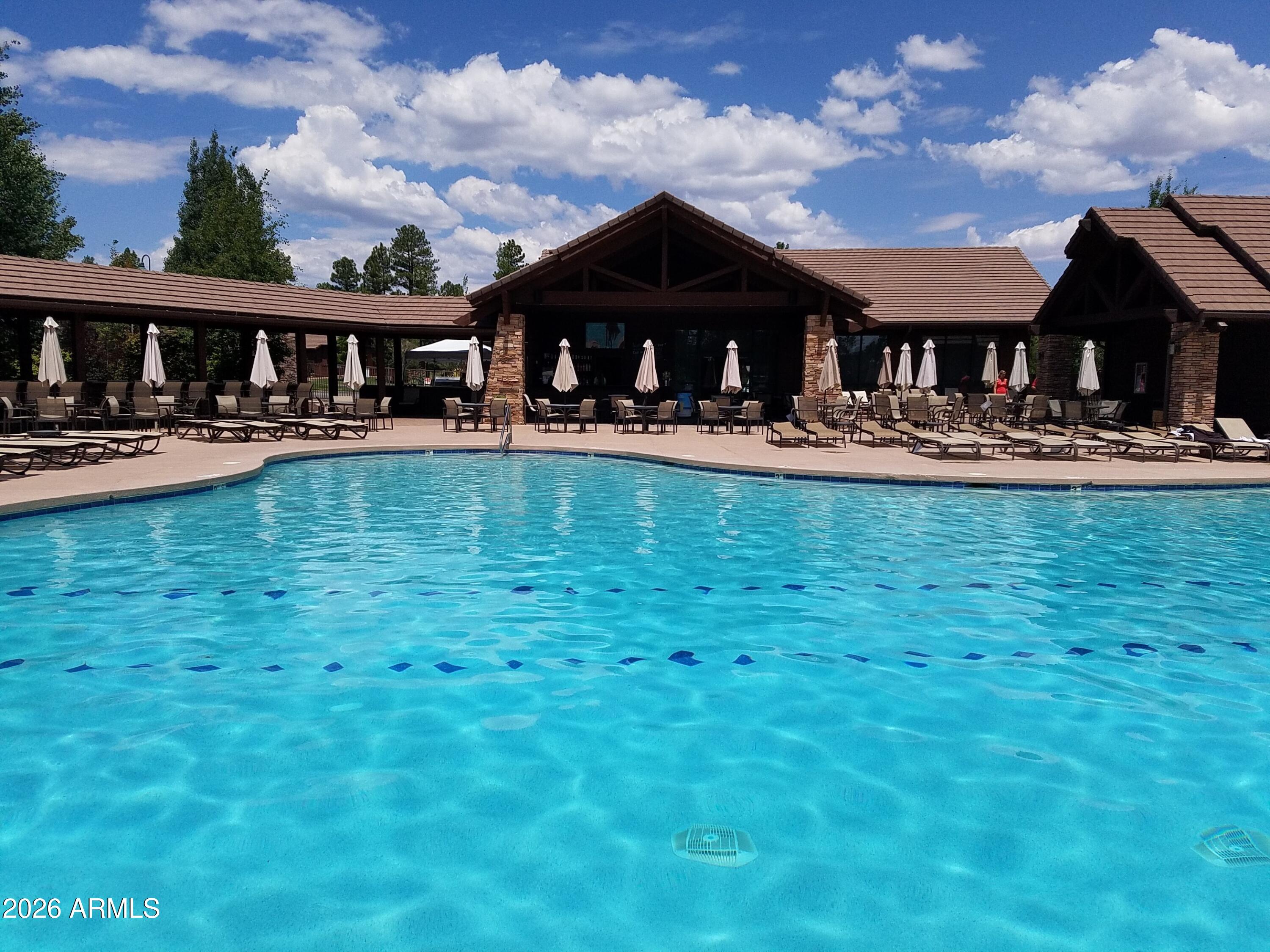 3990 Sugar Pine Loop Show Low, AZ 85901 - Photo 46 of 62 a front view of house with yard entertaining space and seating area