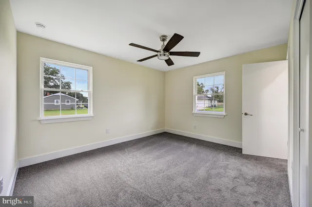 a view of a livingroom with a ceiling fan and window