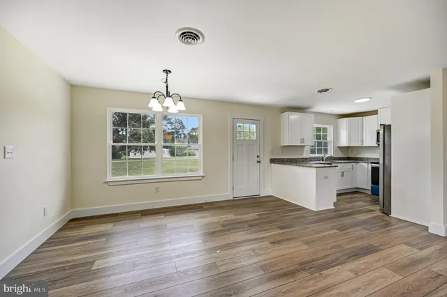 a view of kitchen with refrigerator and window