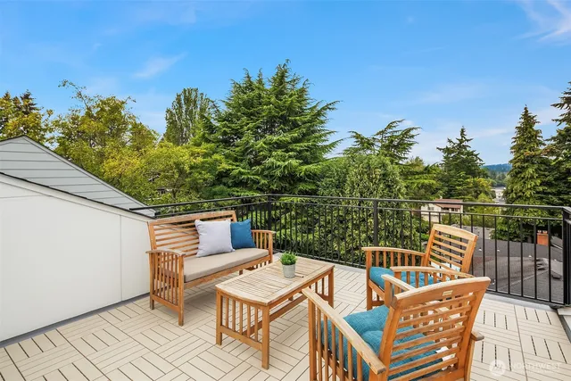 a view of a balcony with wooden floor and outdoor seating