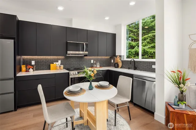 a kitchen with a table chairs and a refrigerator