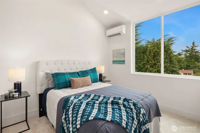 a bedroom with a large bed and a window