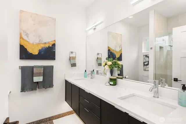 a bathroom with a double vanity sink and a mirror