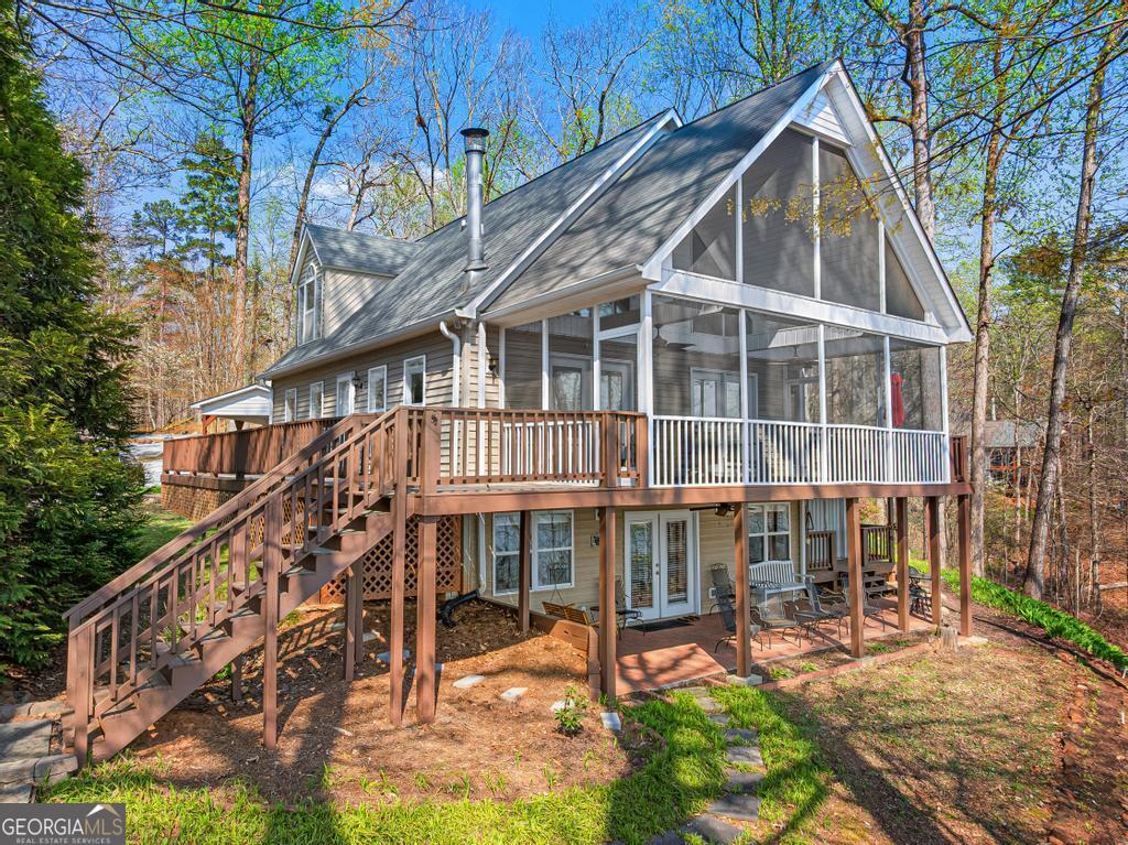 a view of a house with backyard and sitting area
