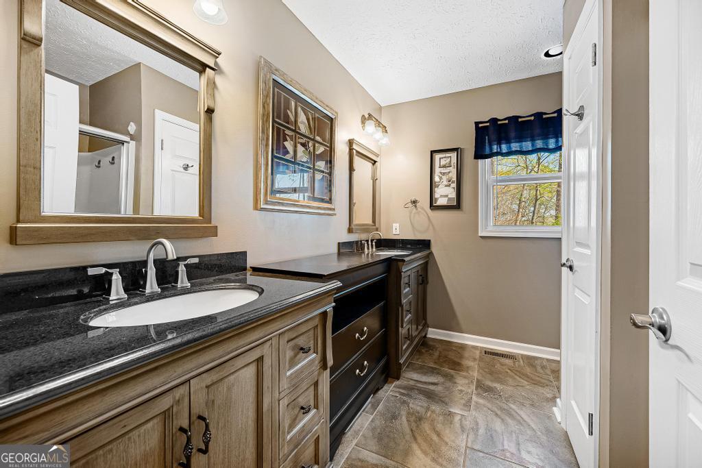 997 Rue Fluer De Lis Lavonia, GA 30553 - Photo 16 of 38 a bathroom with a sink double vanity and a mirror