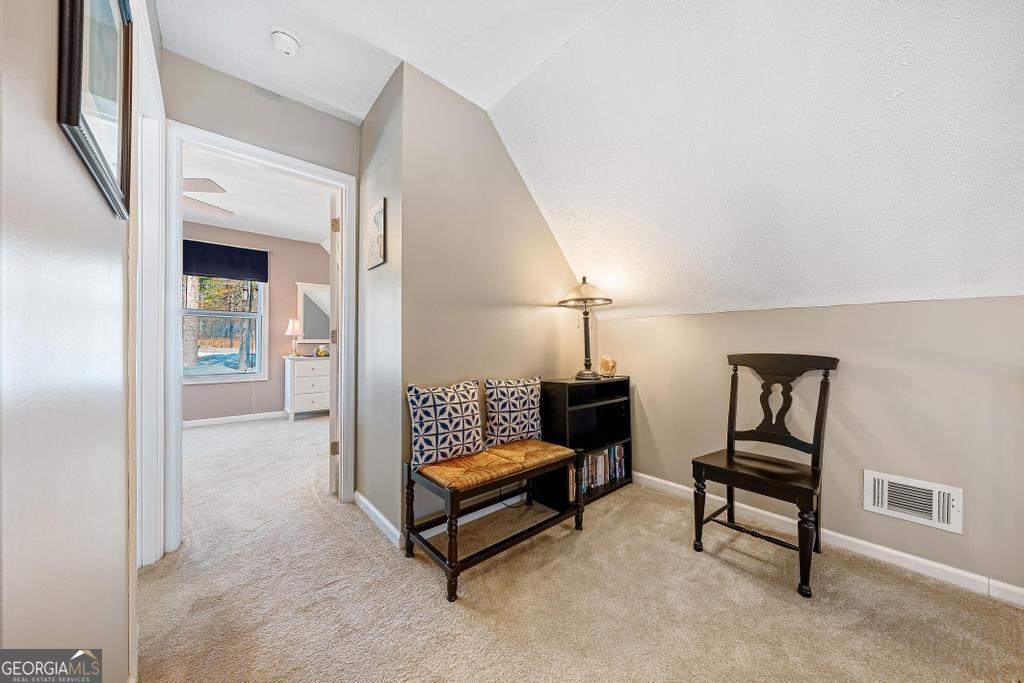 997 Rue Fluer De Lis Lavonia, GA 30553 - Photo 17 of 38 a living room with furniture and a lamp