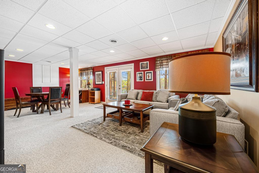 997 Rue Fluer De Lis Lavonia, GA 30553 - Photo 20 of 38 a living room with furniture potted plant and a large window