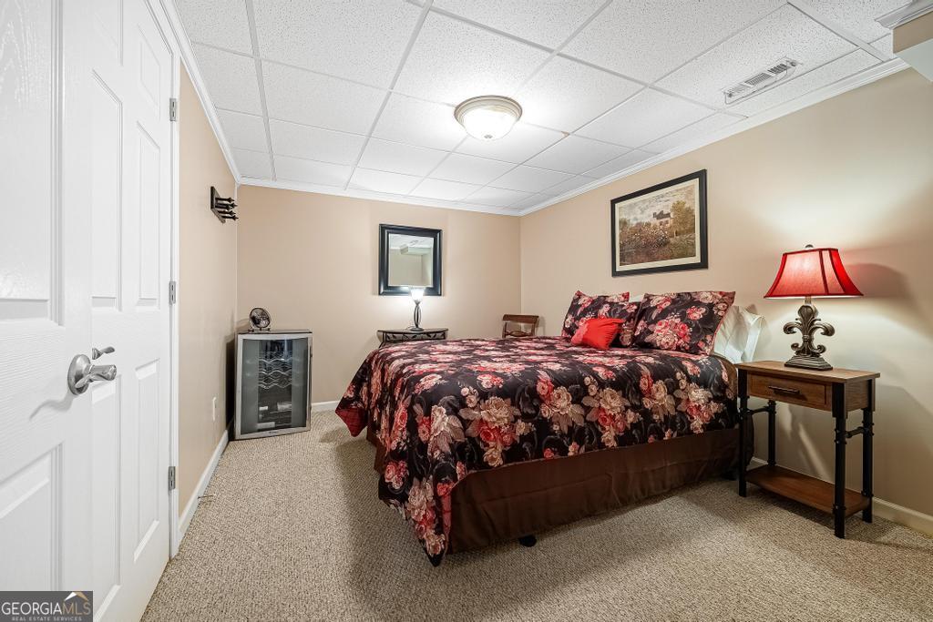 997 Rue Fluer De Lis Lavonia, GA 30553 - Photo 23 of 38 a bed sitting in a bedroom next to a lamp