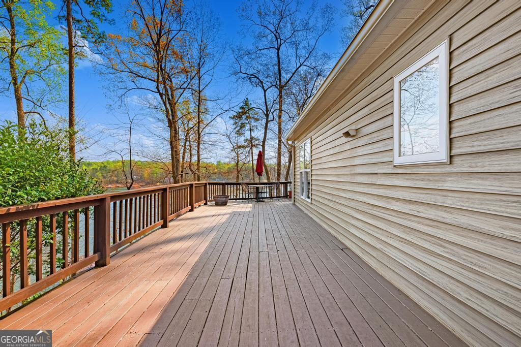 997 Rue Fluer De Lis Lavonia, GA 30553 - Photo 25 of 38 a view of balcony with wooden floor and fence and a floor to ceiling window