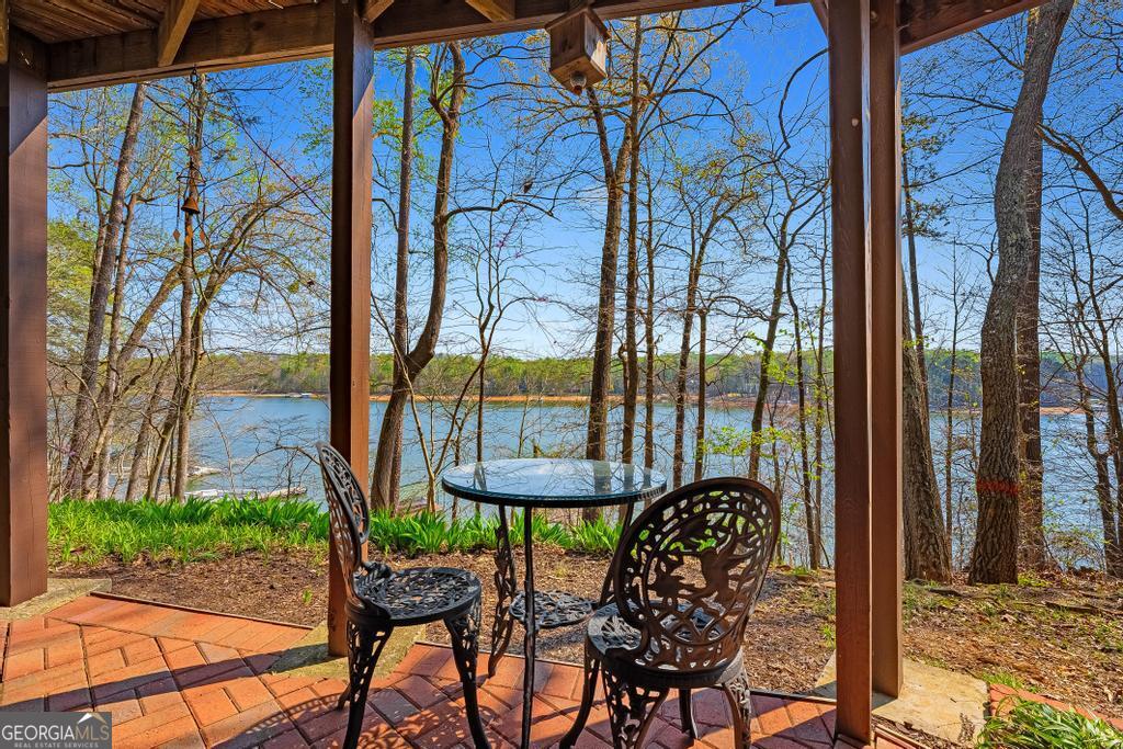 997 Rue Fluer De Lis Lavonia, GA 30553 - Photo 4 of 38 a view of a balcony with table and chairs