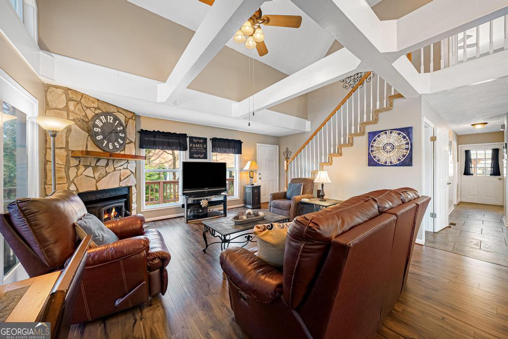 997 Rue Fluer De Lis Lavonia, GA 30553 - Photo 9 of 38 a living room with furniture a flat screen tv and a fireplace