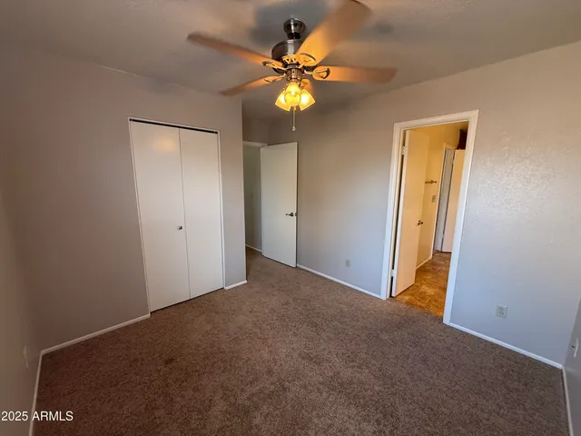 a view of an empty room with a fan