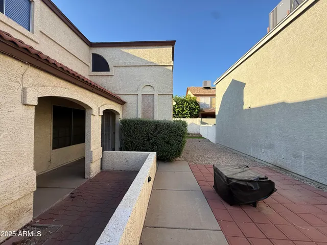 a view of a back yard with a patio