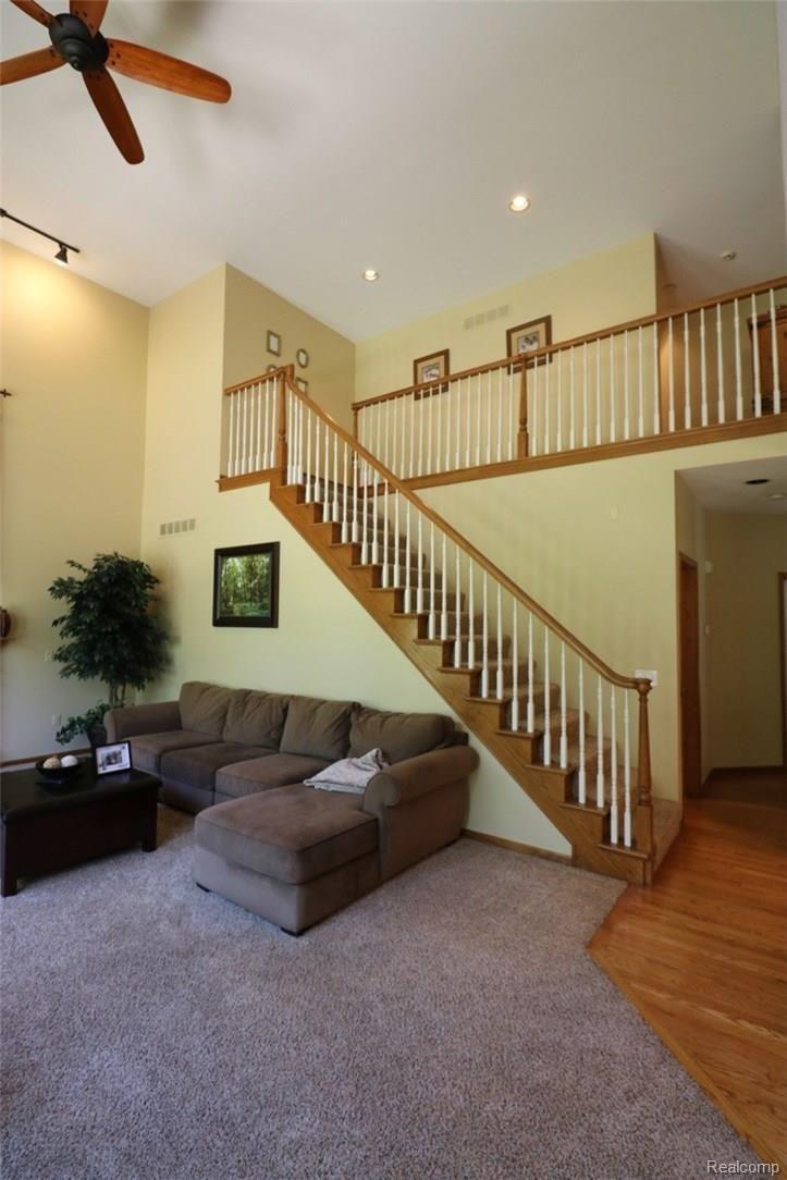 1983 Blue Grass Court Rochester, MI 48306 - Photo 13 of 46 THE 2 STORY GREAT ROOM CONTAINS A CEILING FAN AND ANOTHER STAIRCASE THAT LEADS TO THE 2ND FLOOR