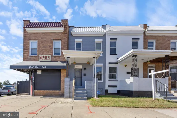 a front view of a building with a garden