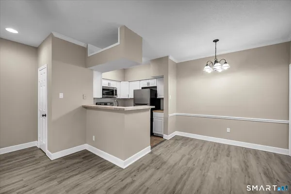 a kitchen with kitchen island a refrigerator and a stove top oven