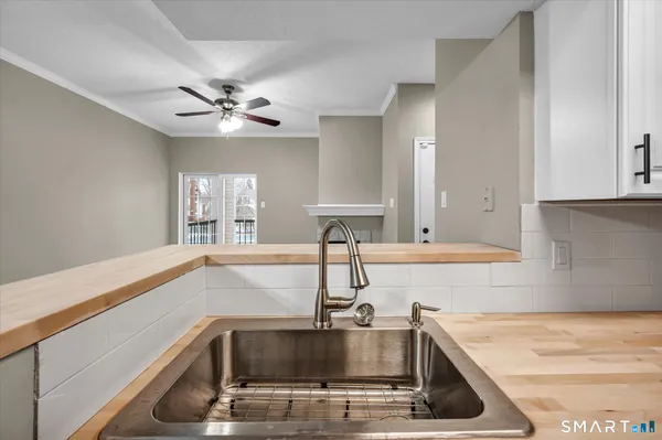 a kitchen with a sink and chandelier