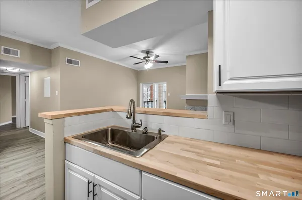 a kitchen with a sink cabinets and window
