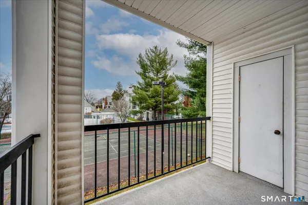 a view of a balcony with a tree