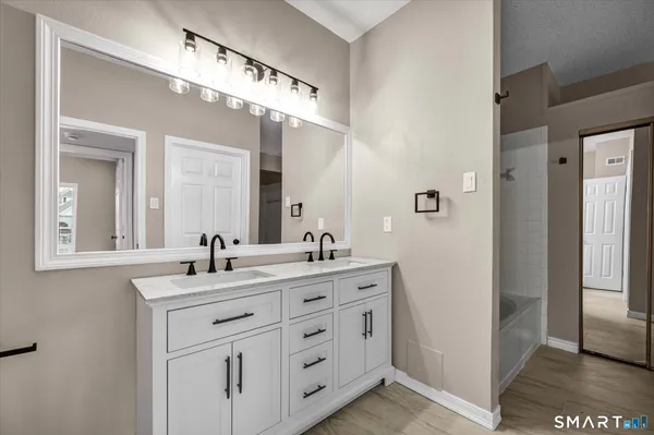 a bathroom with a double vanity sink and mirror