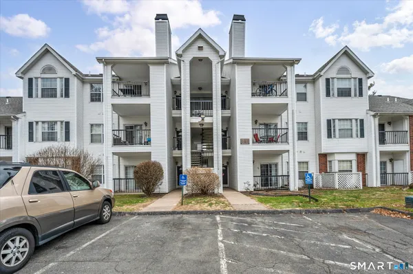 a front view of a residential apartment building with a yard