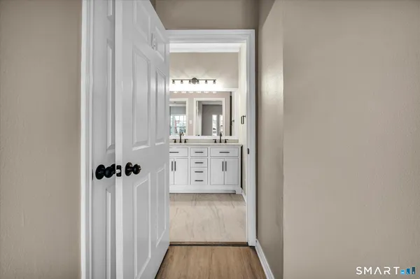 a view of a hallway with wooden floor
