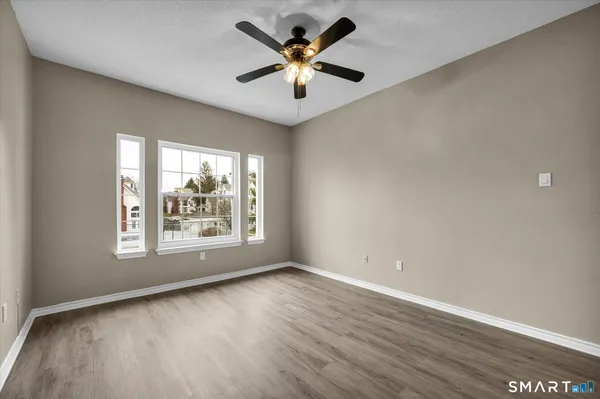 wooden floor in an empty room with a window