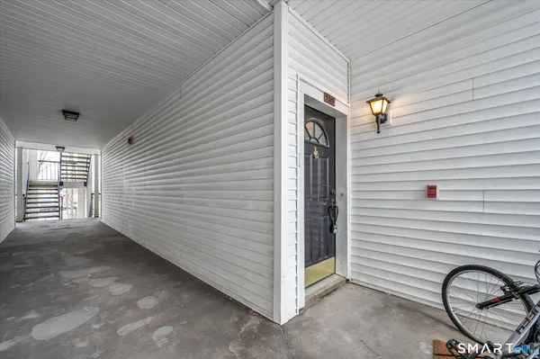 a view of a porch with a table and chairs