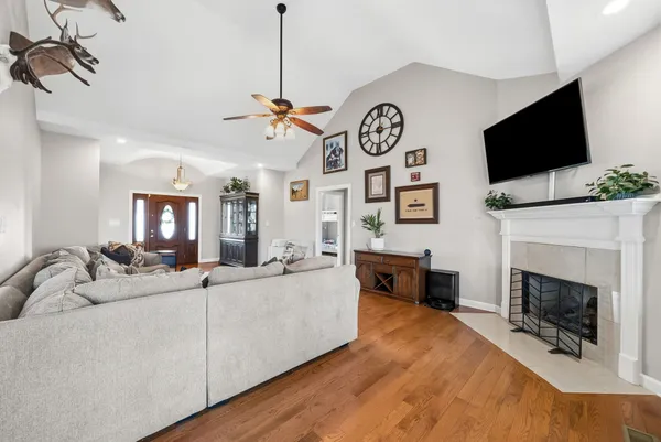 a living room with furniture a flat screen tv and a fireplace