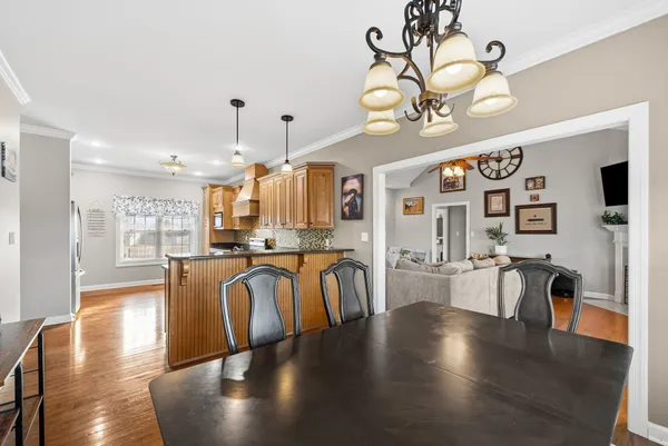 a view of a dining room with furniture wooden floor and chandelier