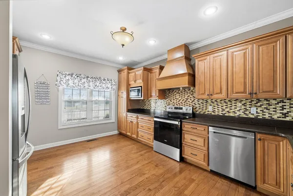 a kitchen with granite countertop a stove and a sink