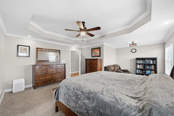a bedroom with a bed and a chandelier