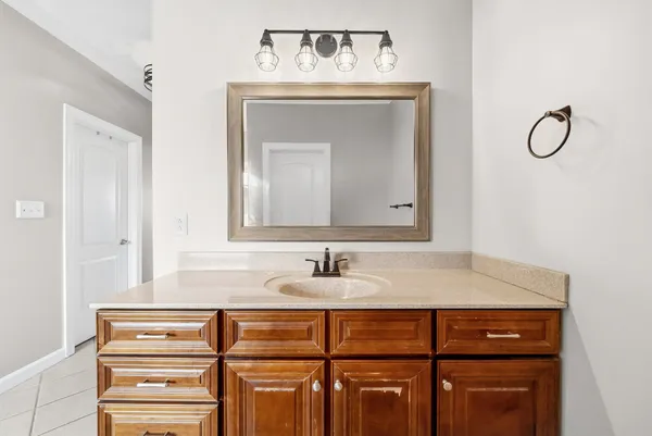 a bathroom with a granite countertop sink and a mirror