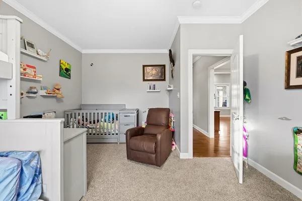 a dining room with furniture a flat screen tv and a large window