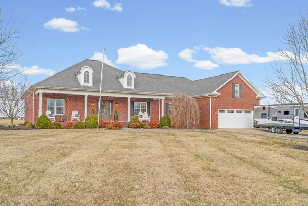 a front view of a house with a yard and garage