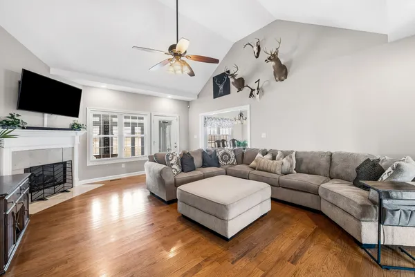 a living room with fireplace furniture and a flat screen tv