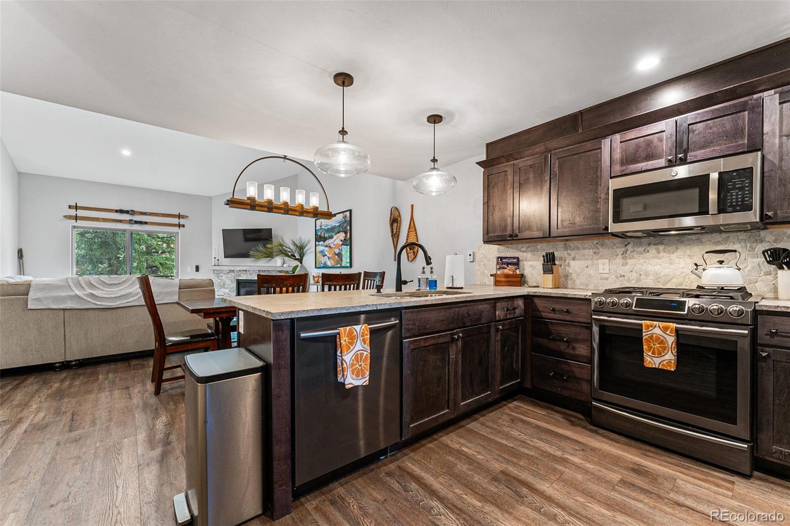 500 Vasquez Road, Unit 7A Winter Park, CO 80482 - Photo 16 of 49 a kitchen with stainless steel appliances granite countertop a stove and a wooden floors