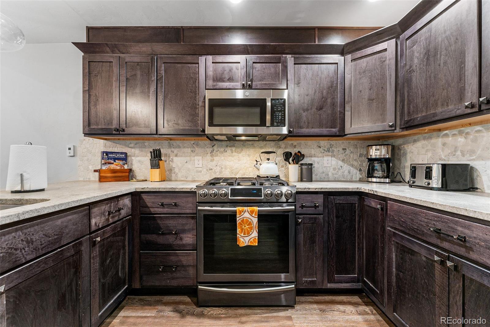 500 Vasquez Road, Unit 7A Winter Park, CO 80482 - Photo 17 of 49 a kitchen with stainless steel appliances granite countertop a stove and a sink