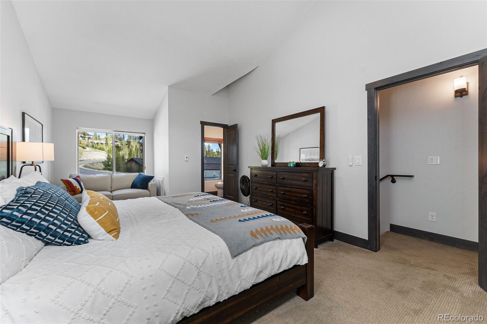 500 Vasquez Road, Unit 7A Winter Park, CO 80482 - Photo 33 of 49 a bedroom with a bed and wooden floor